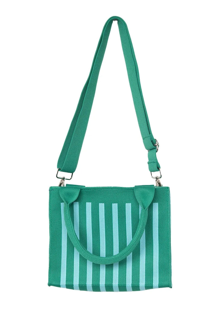 Green and mint stripe mesh mini tote bag worn as a crossbody with the long green adjustable strap, front view.