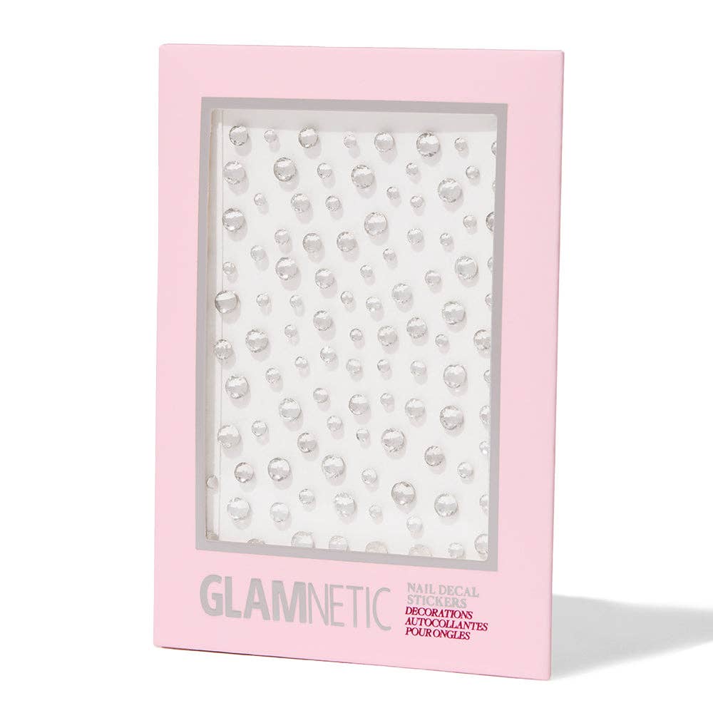 Glamnetic Nail Decal Stickers packaging in pink box showing a sheet of clear rhinestone nail gems in assorted sizes