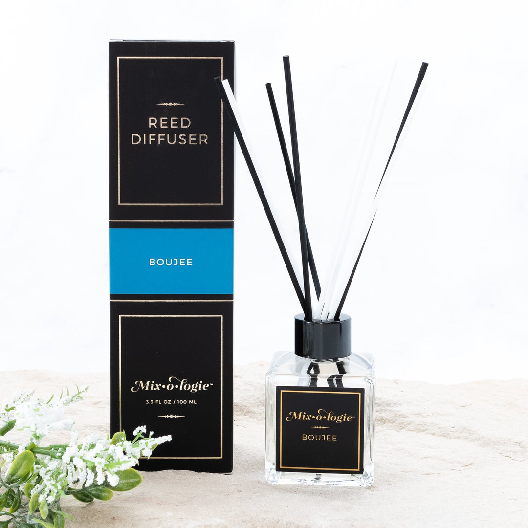 Mixologie Reed Diffuser in Boujee, 3.3 fl oz, clear square glass bottle with black cap and black label, with matching black and teal box