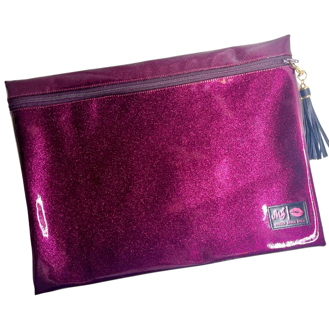 Makeup Junkie Bags magenta hot pink glitter large zip makeup bag with navy tassel zipper pull and branded patch, front view on white background