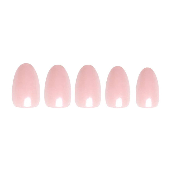 Flatlay of 5 blush pink short oval press-on nails in graduating sizes showing glossy finish on white background
