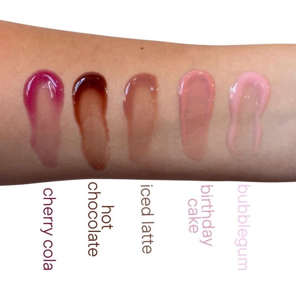 TMLL Beauty Co Pout Plump lip oil swatches in five shades on wrist — cherry cola, hot chocolate, iced latte, birthday cake, and bubblegum