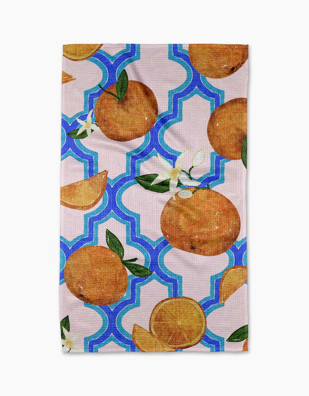 Tea towel featuring illustrated oranges, orange slices, and white blossoms on a blue Moroccan trellis pattern with a pink background