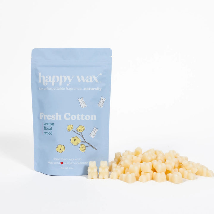 Happy Wax Fresh Cotton light blue pouch with cream bear-shaped wax melts piled in front, on a white background.
