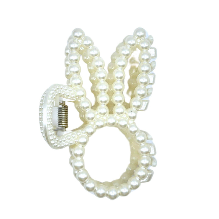 Pearl beaded bunny ear claw clip product shot on white background showing front view of bunny ear silhouette and spring claw mechanism.