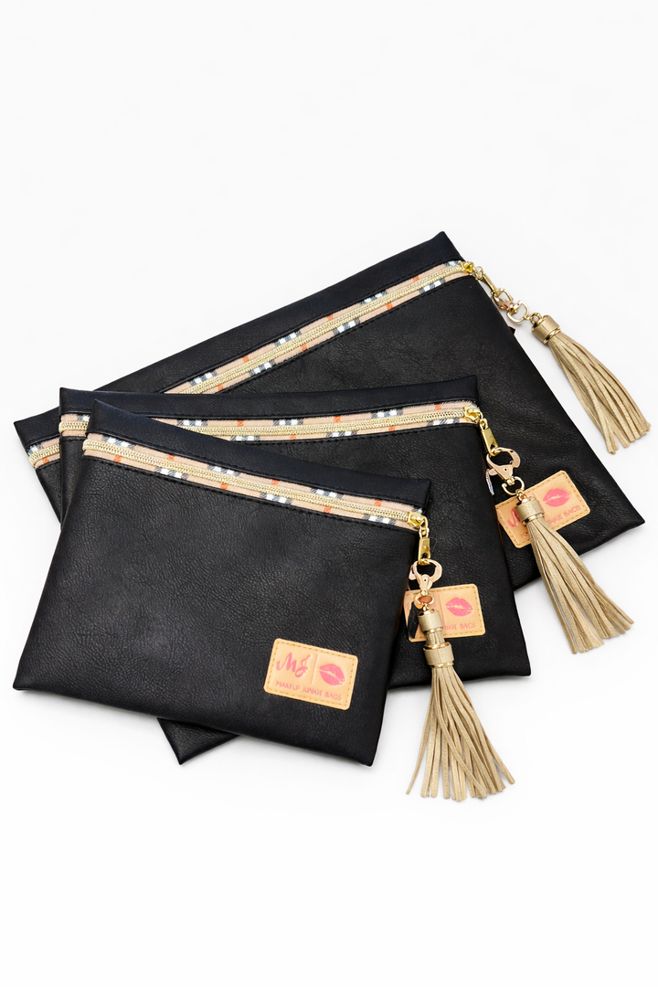 Makeup Junkie Bags black vegan leather zip pouches in three sizes with plaid-trim gold zipper and taupe tassels
