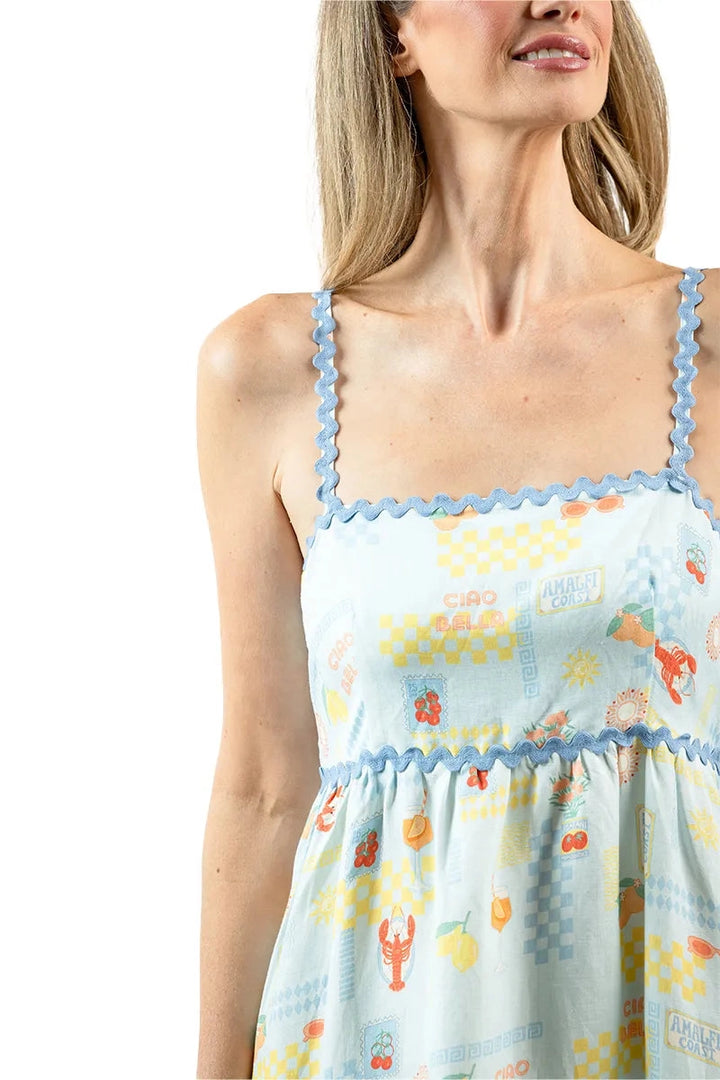 Close-up of square neckline and spaghetti straps of a light blue lobster and summer print maxi dress with blue ric-rac trim detail at the bust and waist.