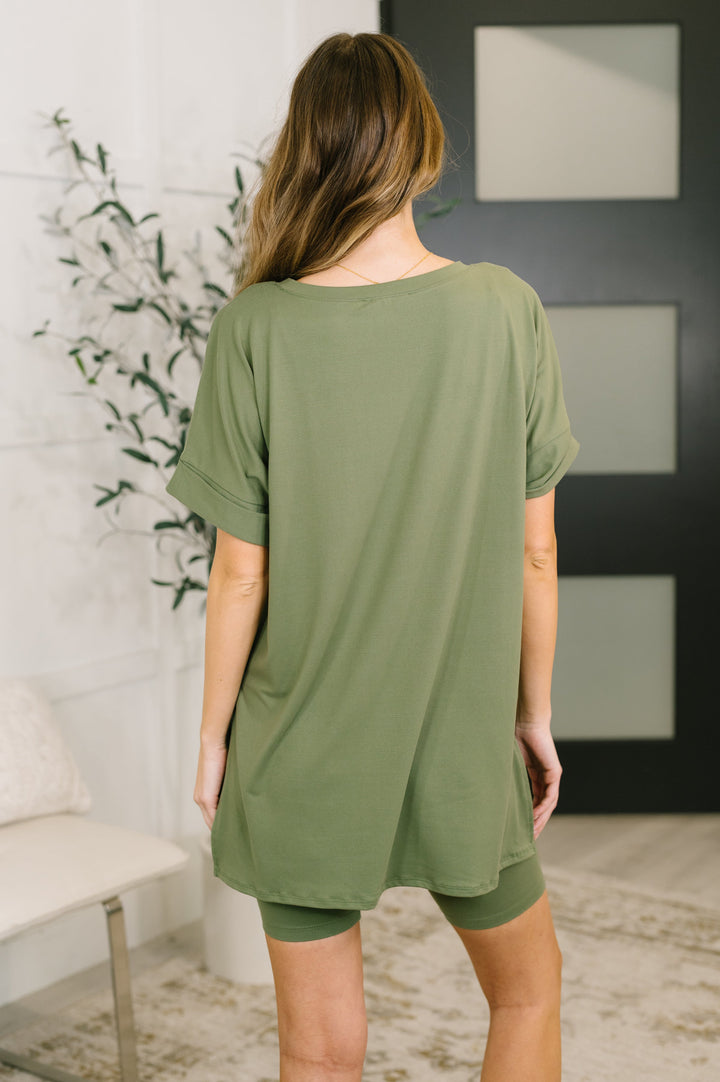 Back view — light olive green oversized V-neck tee and biker shorts set