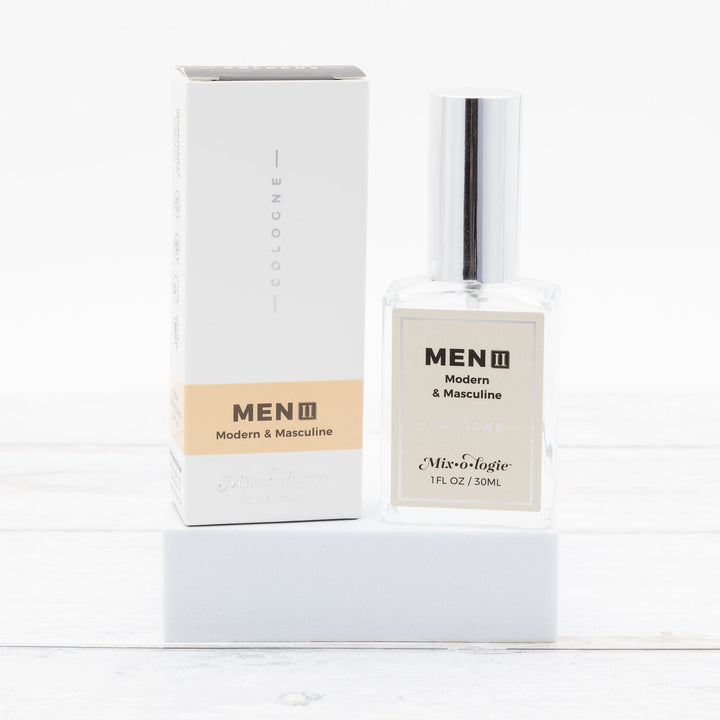 Mixologie Men II Modern & Masculine Cologne, 1 fl oz, clear square glass spray bottle with silver cap and cream label with matching white and tan box