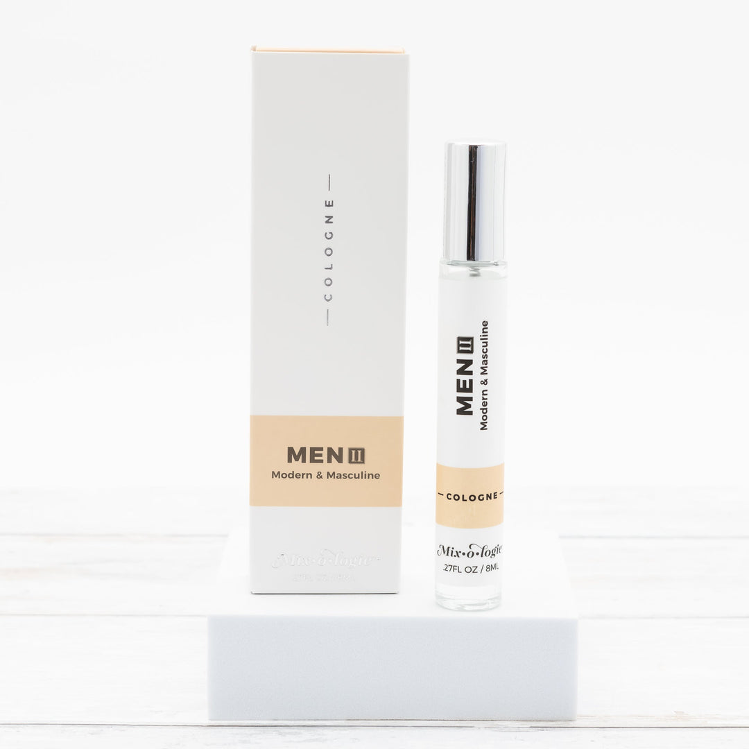 Mixologie Men II Modern & Masculine Cologne, 0.27 fl oz, clear glass roller bottle with silver cap and tan label with matching white and tan box