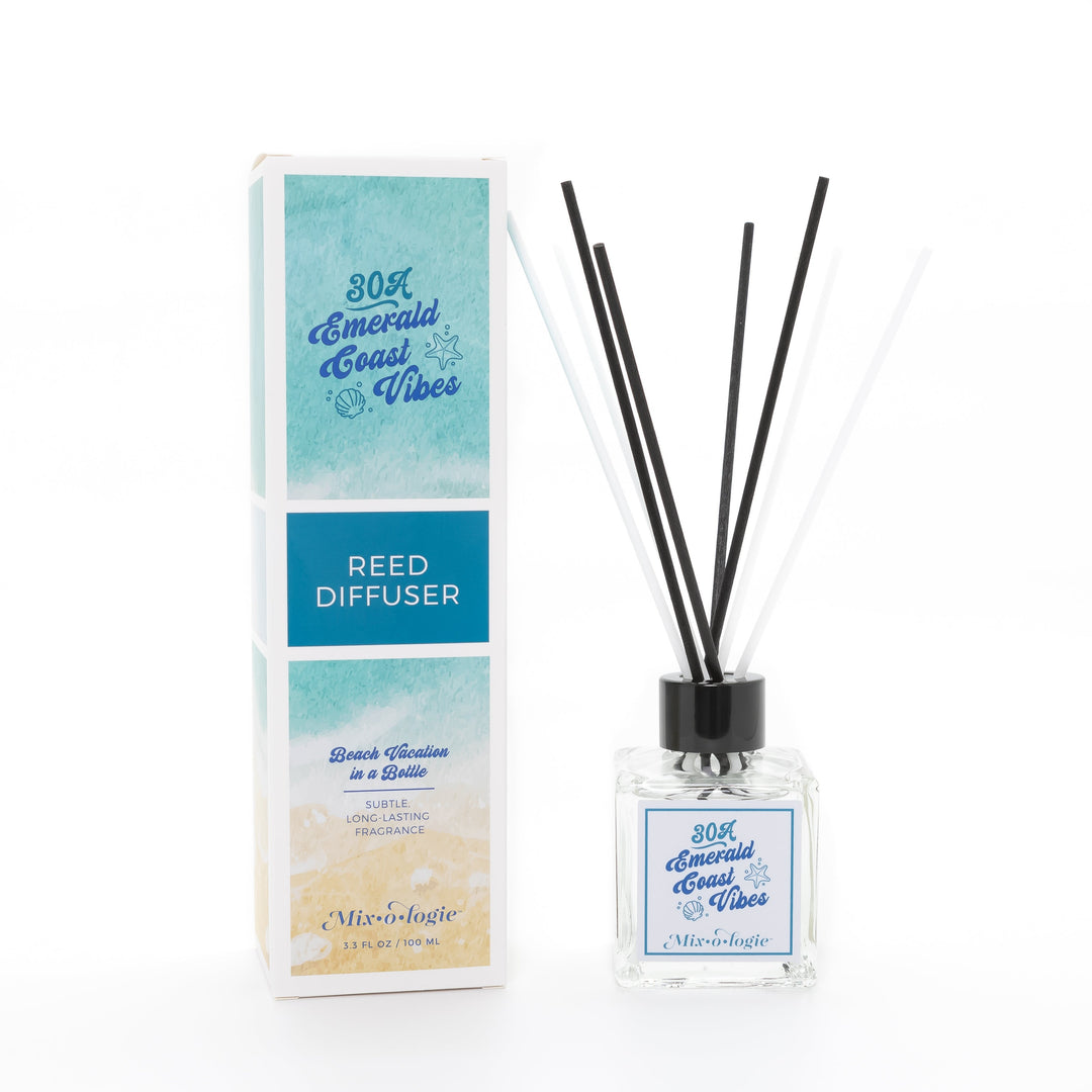 Mixologie Reed Diffuser in 30A Emerald Coast Vibes, 3.3 fl oz, clear square glass bottle with black cap and teal script label, with matching watercolor beach and teal box