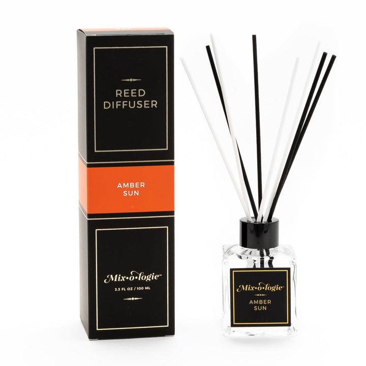 Mixologie Reed Diffuser in Amber Sun, 3.3 fl oz, clear square glass bottle with black cap and black label with orange accent band, with matching black and orange box
