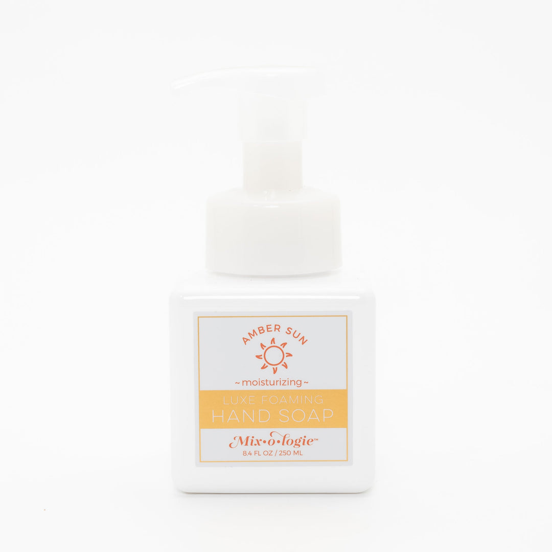 Mixologie Luxe Foaming Hand Soap in Amber Sun, 8.4 fl oz, white square pump bottle with gold-bordered label and orange sun illustration on white background