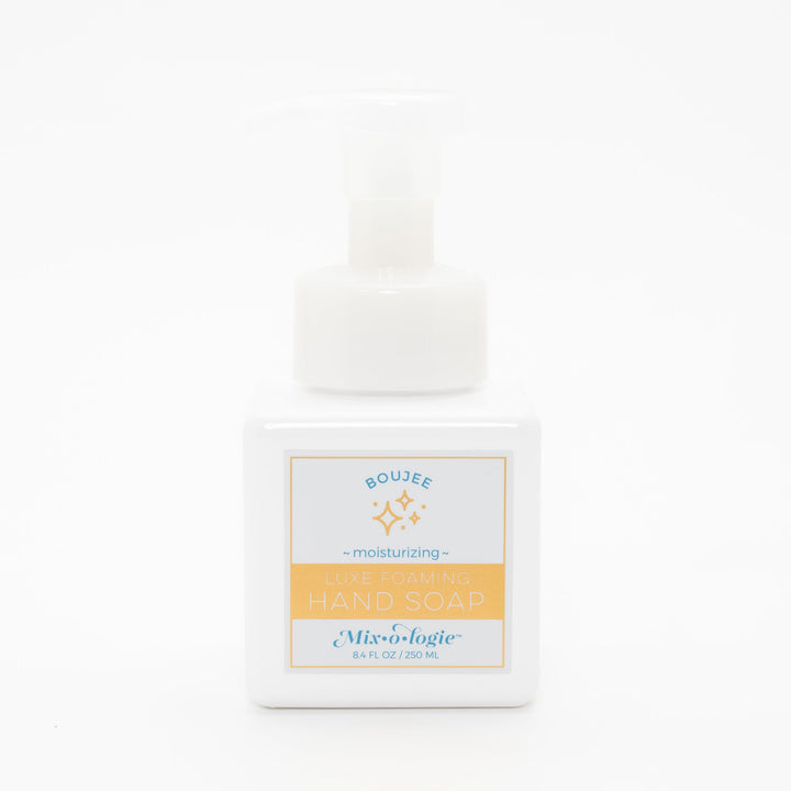 Mixologie Luxe Foaming Hand Soap in Boujee, 8.4 fl oz, white square pump bottle with gold-bordered label and teal and gold sparkle star illustration on white background
