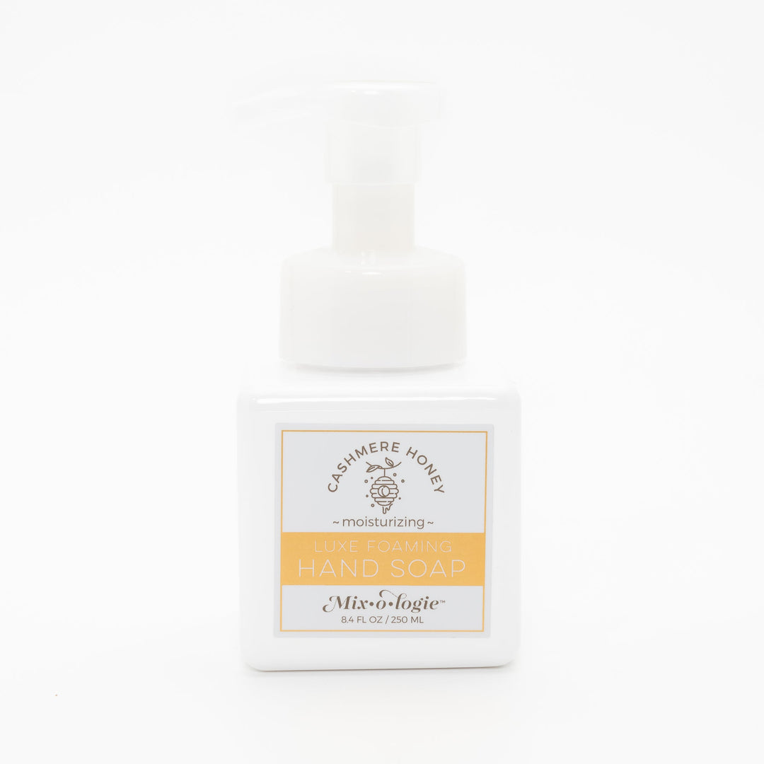Mixologie Luxe Foaming Hand Soap in Cashmere Honey, 8.4 fl oz, white square pump bottle with gold-bordered label and honeycomb beehive illustration on white background