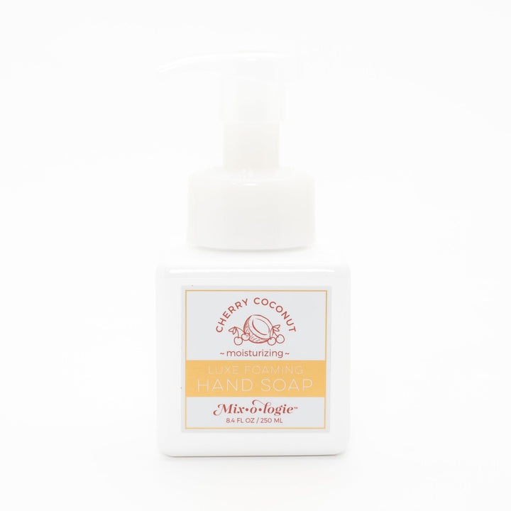 Mixologie Luxe Foaming Hand Soap in Cherry Coconut, 8.4 fl oz, white square pump bottle with gold-bordered label and red cherry coconut illustration on white background