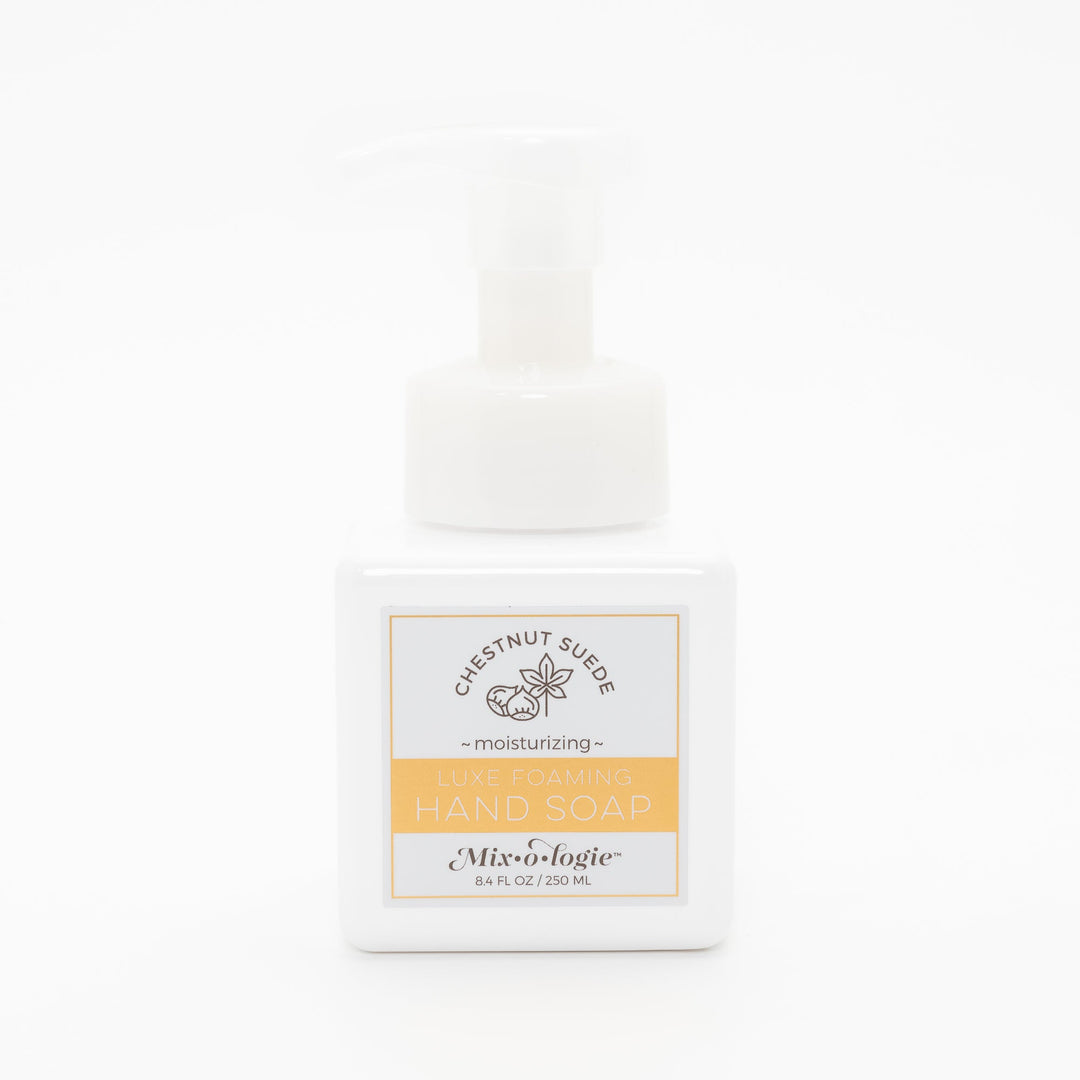 Mixologie Luxe Foaming Hand Soap in Chestnut Suede, 8.4 fl oz, white square pump bottle with gold-bordered label and chestnut botanical illustration on white background