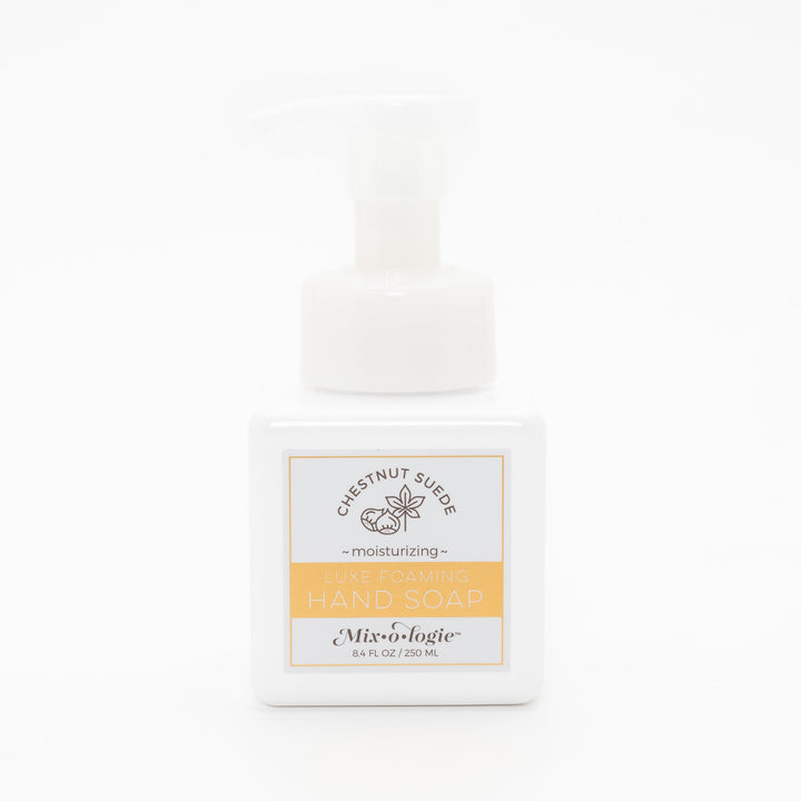 Mixologie Luxe Foaming Hand Soap in Chestnut Suede, 8.4 fl oz, white square pump bottle with gold-bordered label and chestnut botanical illustration on white background