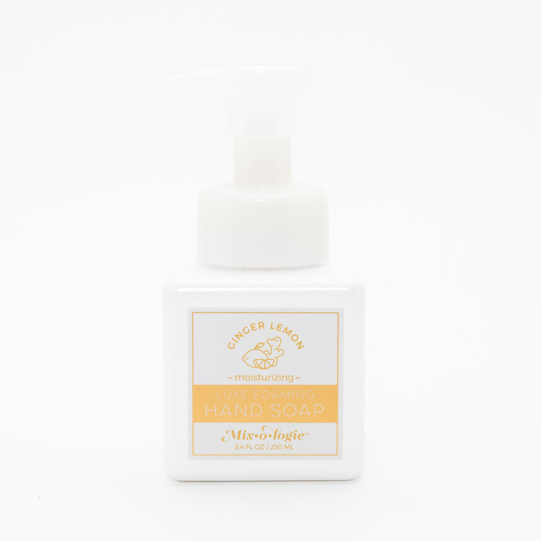 Mixologie Luxe Foaming Hand Soap in Ginger Lemon, 8.4 fl oz, white square pump bottle with gold-bordered label and gold lemon and ginger root illustration on white background