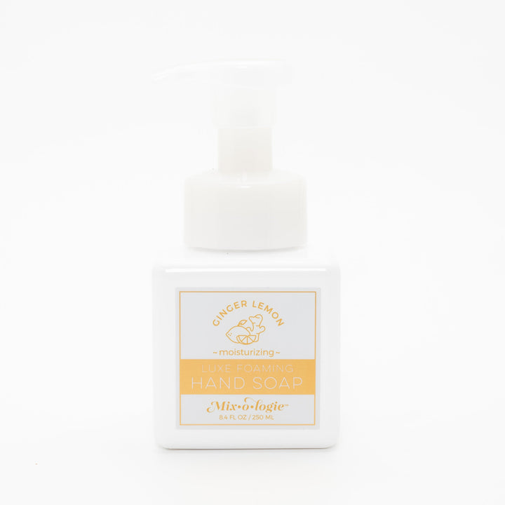 Mixologie Luxe Foaming Hand Soap in Ginger Lemon, 8.4 fl oz, white square pump bottle with gold-bordered label and gold lemon and ginger root illustration on white background
