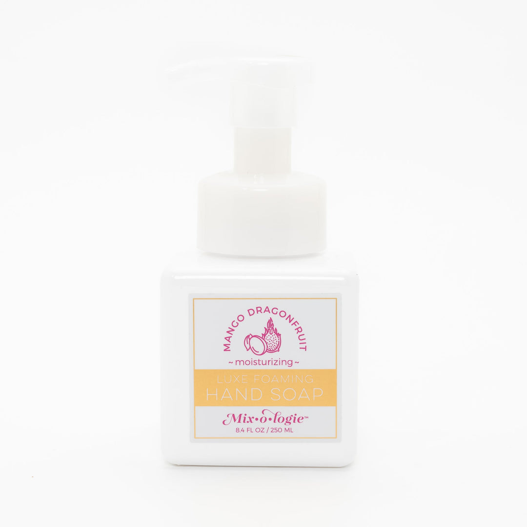 Mixologie Luxe Foaming Hand Soap in Mango Dragonfruit, 8.4 fl oz, white square pump bottle with gold-bordered label and pink mango and dragonfruit illustration on white background