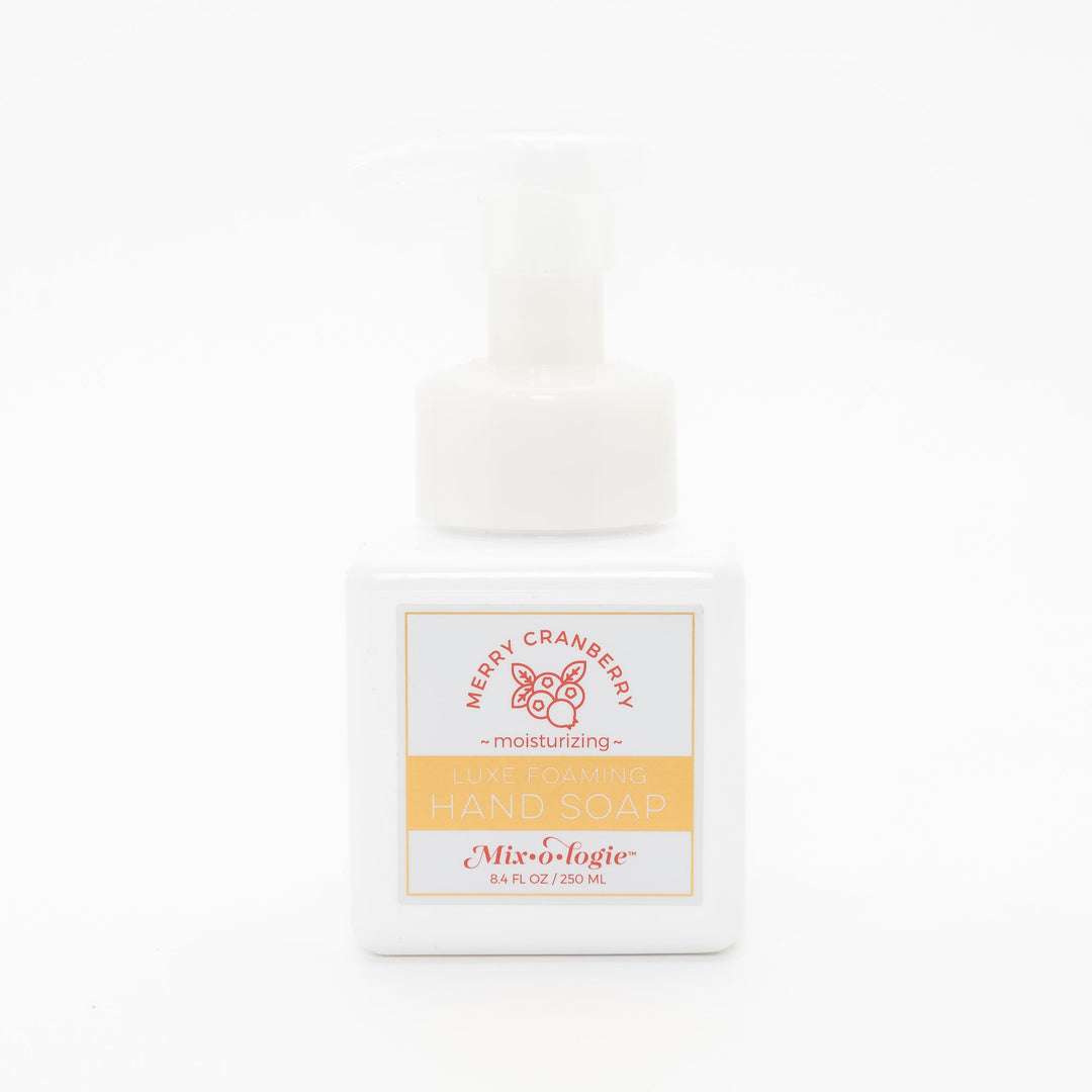Mixologie Luxe Foaming Hand Soap in Merry Cranberry, 8.4 fl oz, white square pump bottle with gold-bordered label and red cranberry branch illustration on white background