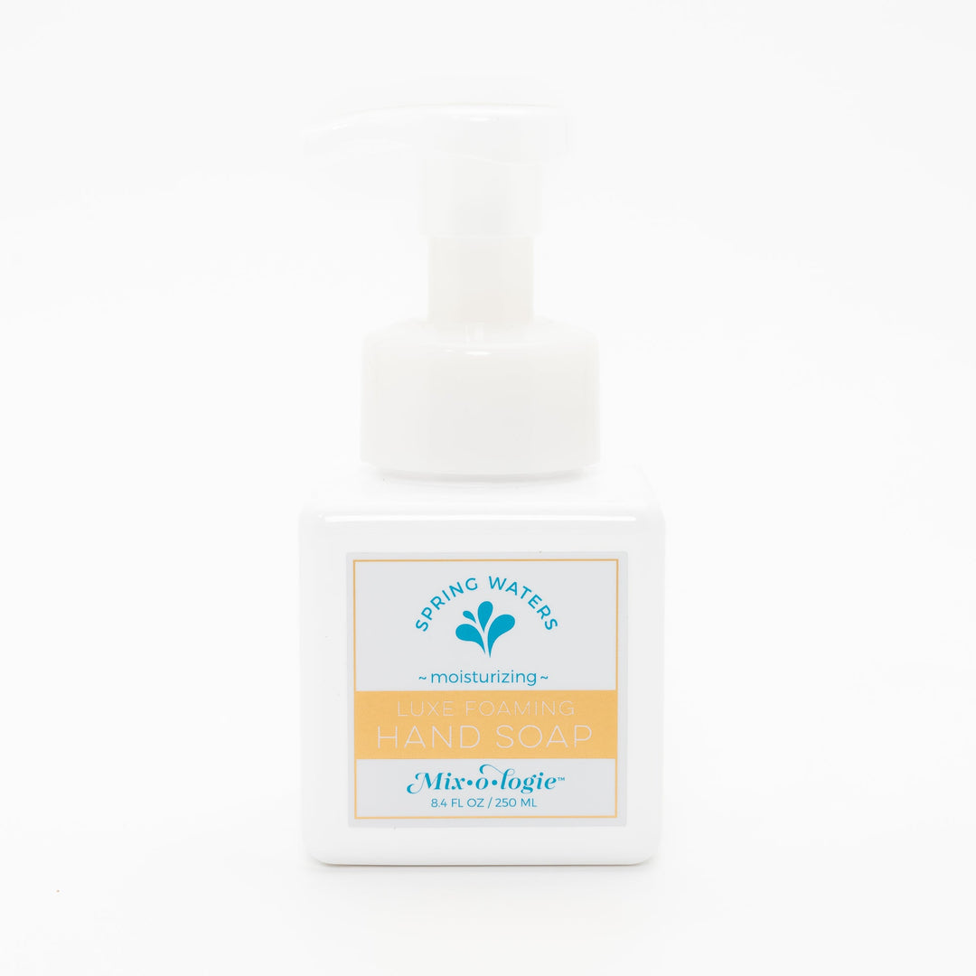 Mixologie Luxe Foaming Hand Soap in Spring Waters, 8.4 fl oz, white square pump bottle with gold-bordered label and teal water droplet splash illustration on white background
