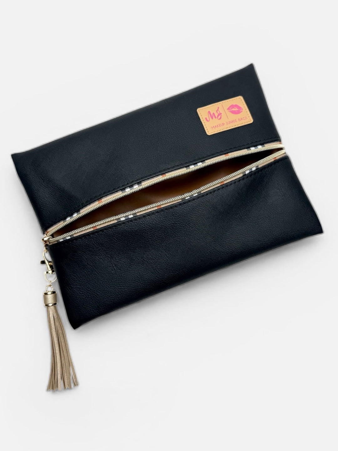Makeup Junkie Bags black vegan leather zip pouch open to show interior, with plaid-trim zipper and taupe tassel