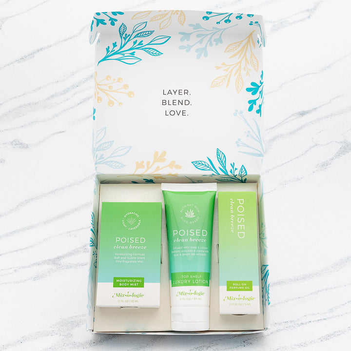 Mixologie Poised Clean Breeze gift set trio open box showing Moisturizing Body Mist, Top Shelf Luxury Lotion, and Roll-On Perfume Oil in bright green gradient packaging