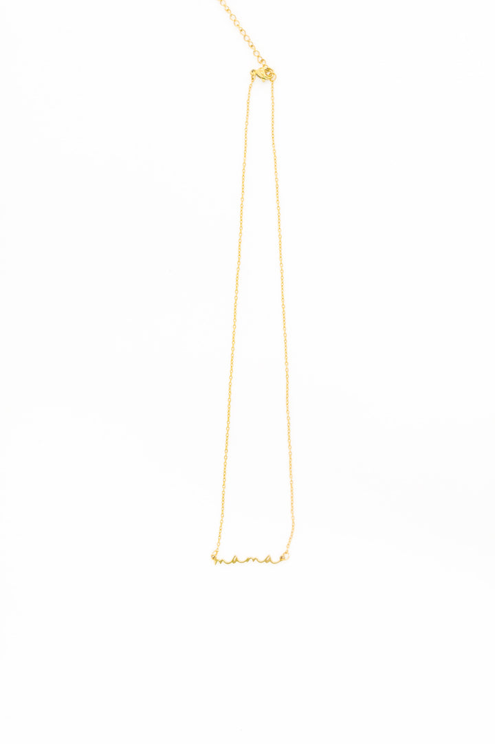 Gold delicate chain necklace with "mama" script pendant on white background