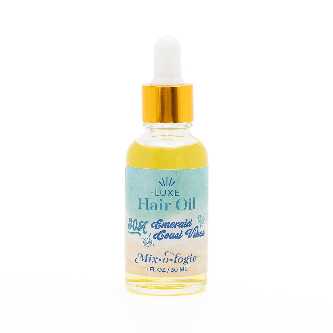 Mixologie Luxe Hair Oil in 30A Emerald Coast Vibes, 1 fl oz, clear dropper bottle with gold cap and teal to sand watercolor label with seashell and starfish accents
