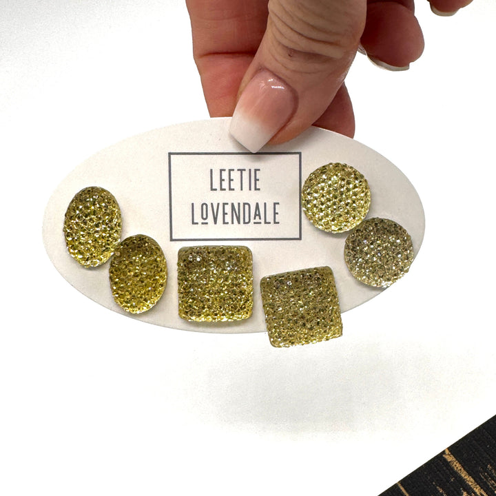 Yellow textured stud earrings on a white card with Leetie Lovendale branding on a white background.