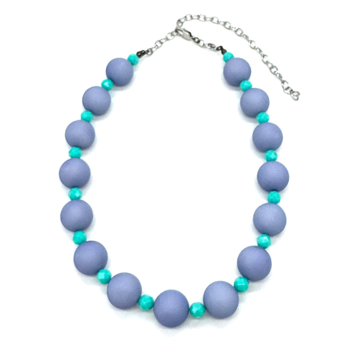 Adjustable necklace featuring chunky periwinkle lucite beads and smaller faceted turquoise spacers on a white background.