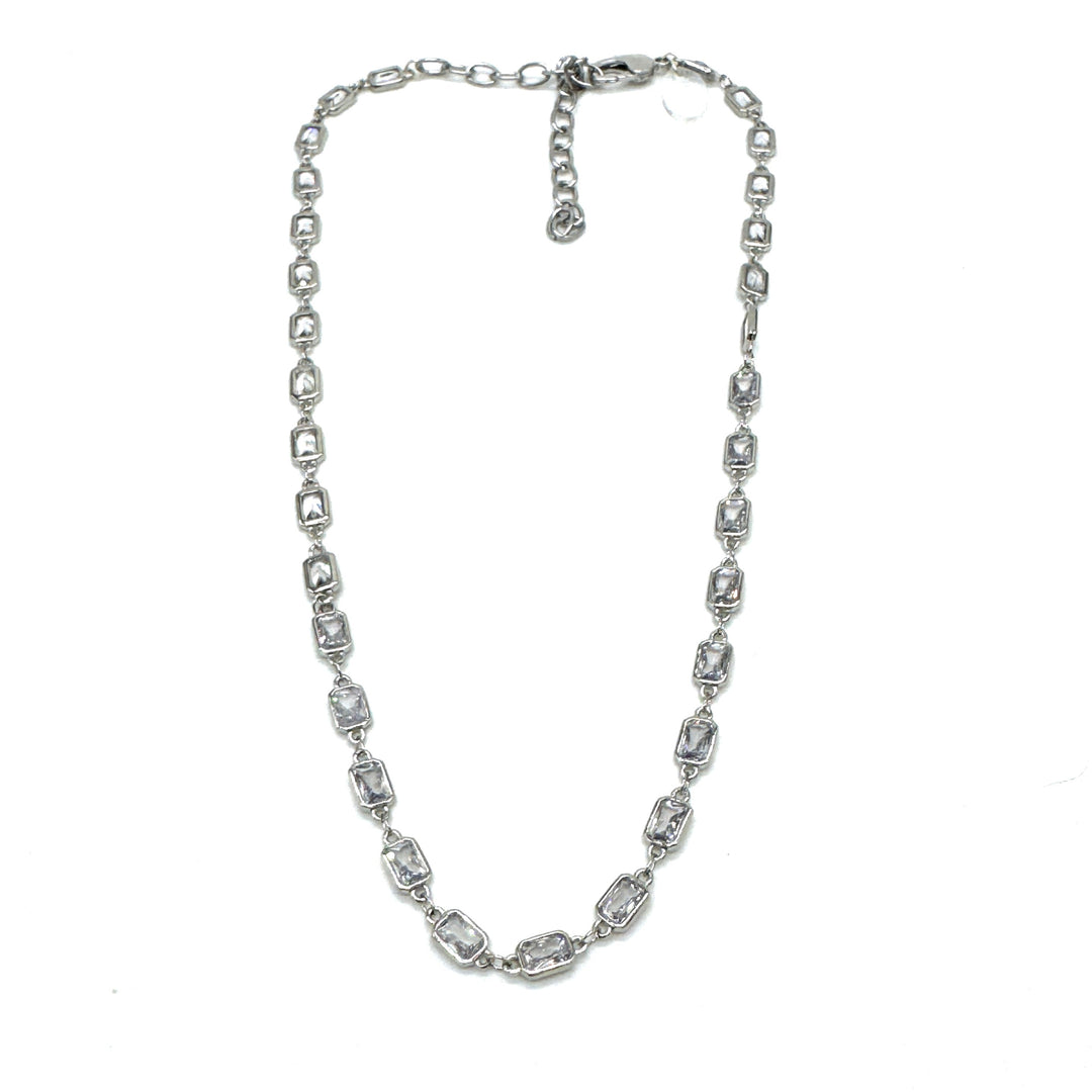 Silver necklace with clear stones on a white background