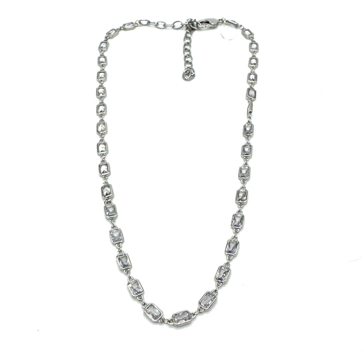 Silver necklace with clear stones on a white background