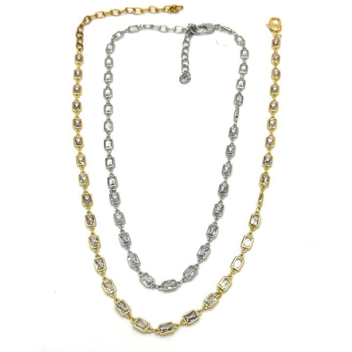 Two gold and silver chain necklaces on a white background