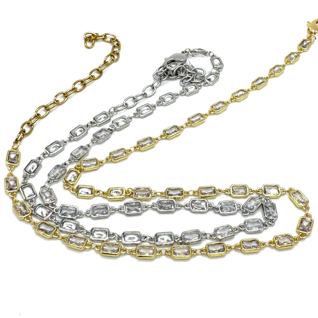 Two gold and silver chain necklaces on a white background