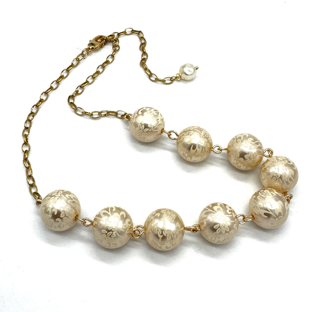 Half chain and half beaded necklace, featuring gold chain and floral etched pearl lucite beads.