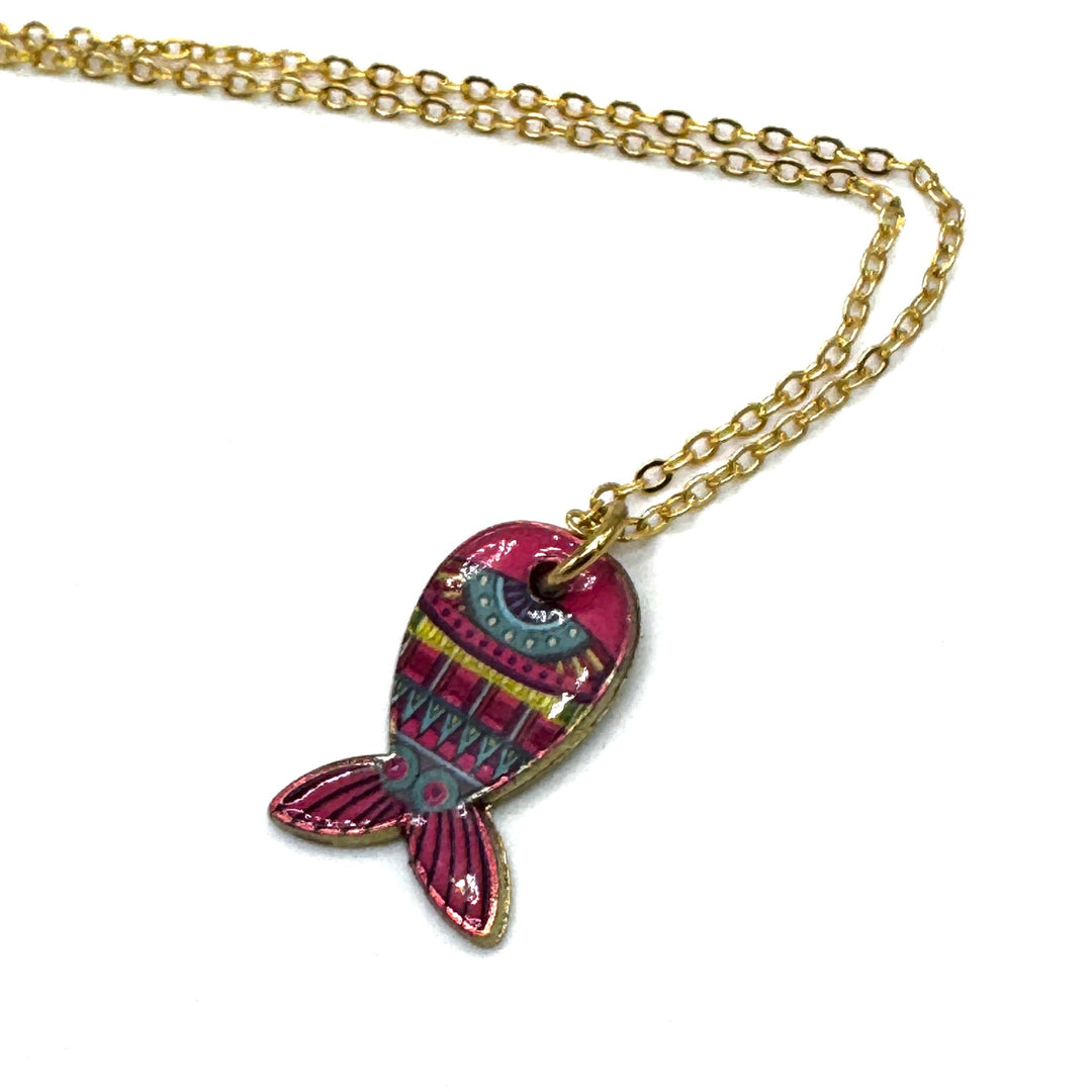 A gold chain necklace featuring a colorful fish-shaped pendant with pink, teal, and yellow patterns, set against a plain white background.