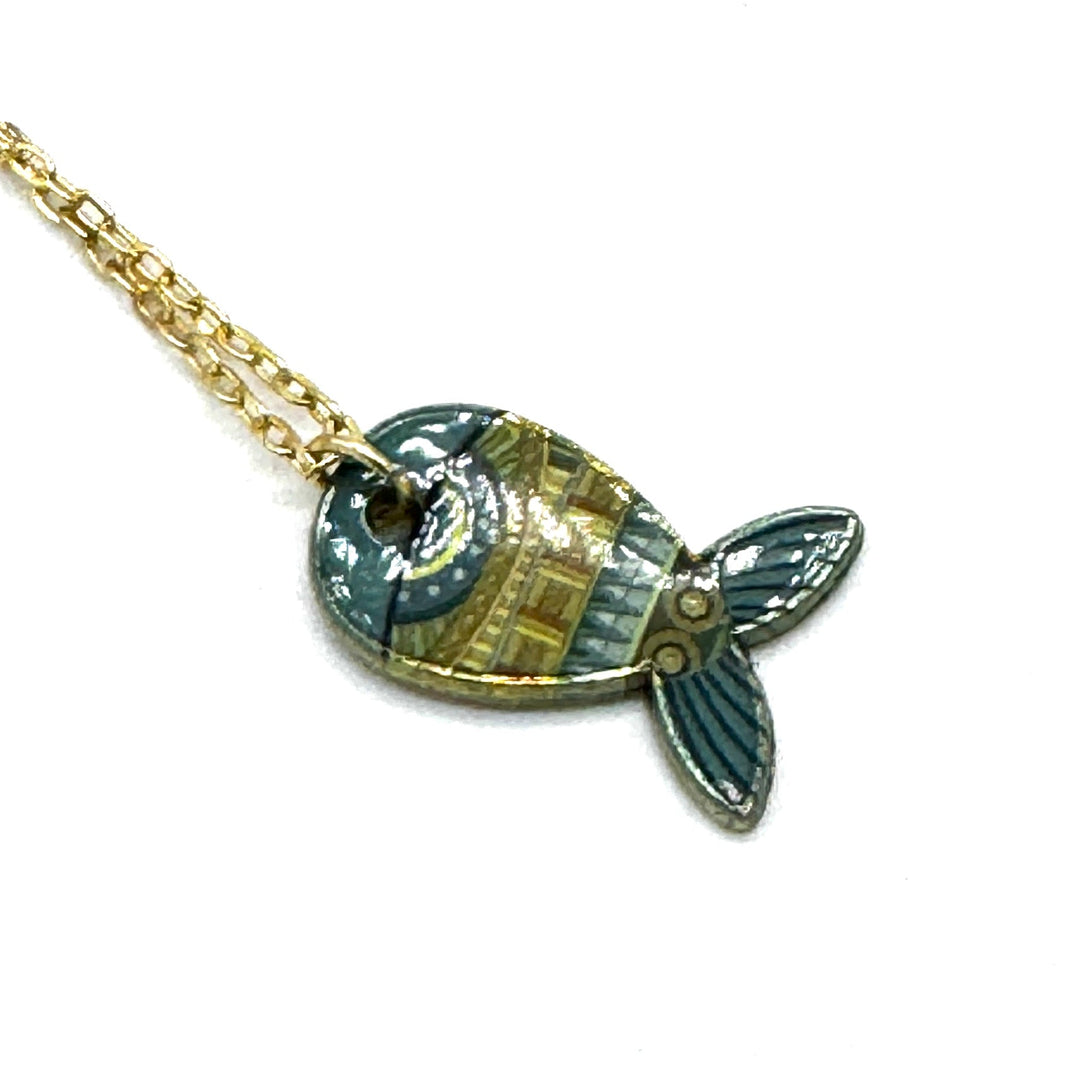 A gold chain necklace with a fish-shaped pendant featuring a mosaic of blue, green, and gold tiles, set against a plain white background.