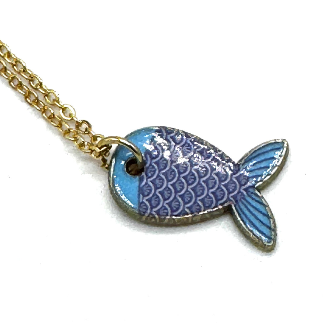 A gold chain necklace with a fish-shaped pendant featuring light blue and purple enamel scales, shown on a plain white background.