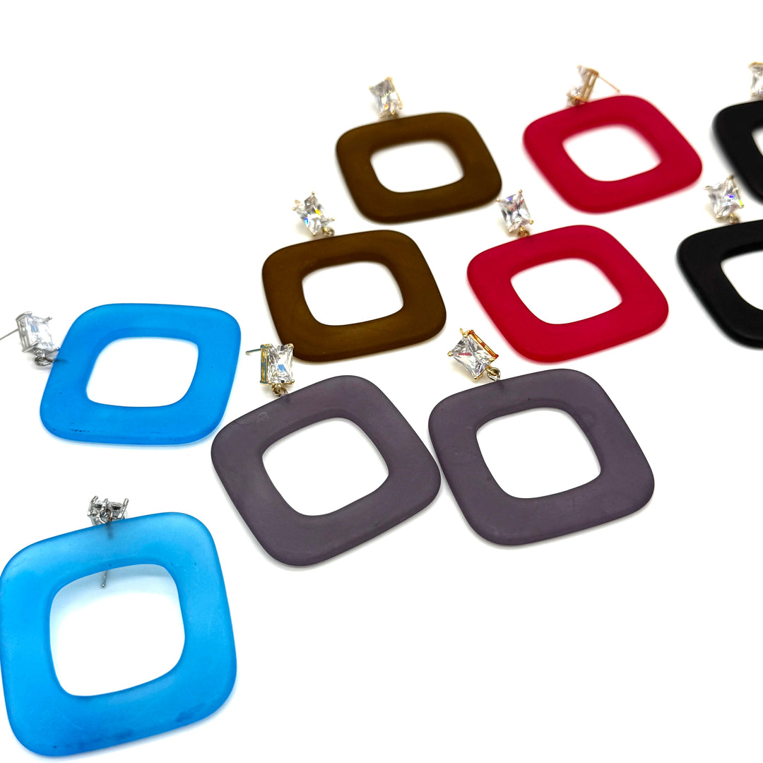 A set of square-shaped drop earrings with rounded corners and a hollow center, shown in multiple colors including blue, brown, red, black, and gray. All earrings feature clear rhinestone studs, all displayed on a clean white background.