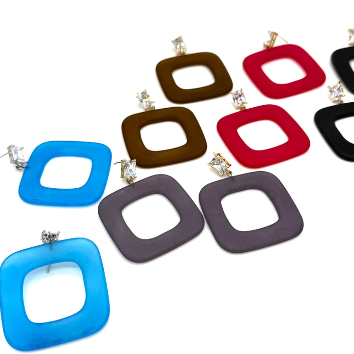 A set of square-shaped drop earrings with rounded corners and a hollow center, shown in multiple colors including blue, brown, red, black, and gray. All earrings feature clear rhinestone studs, all displayed on a clean white background.