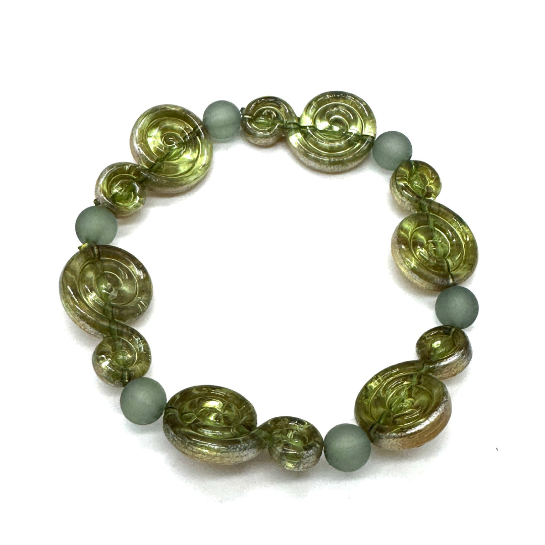 A beaded stretch bracelet featuring textured olive green spiral beads and matte sage green round beads, displayed on a clean white background.