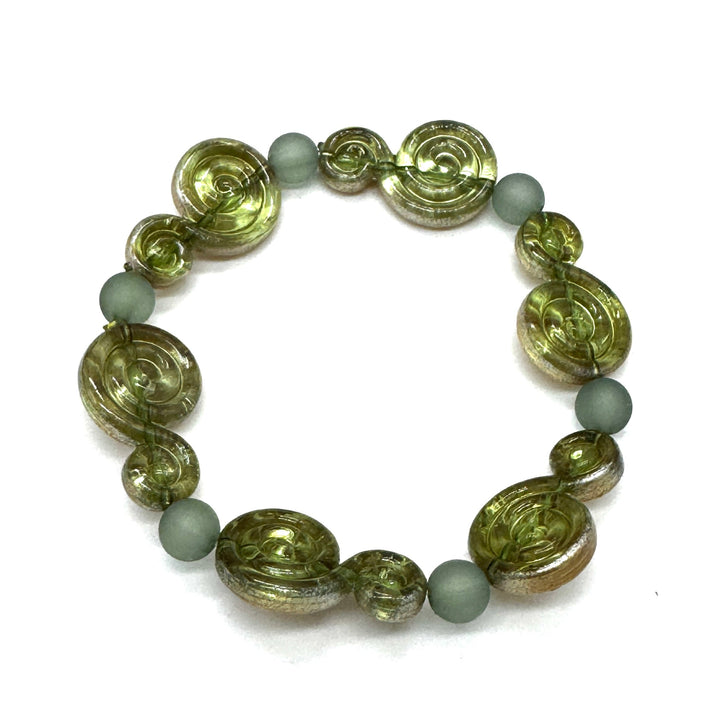 A beaded stretch bracelet featuring textured olive green spiral beads and matte sage green round beads, displayed on a clean white background.