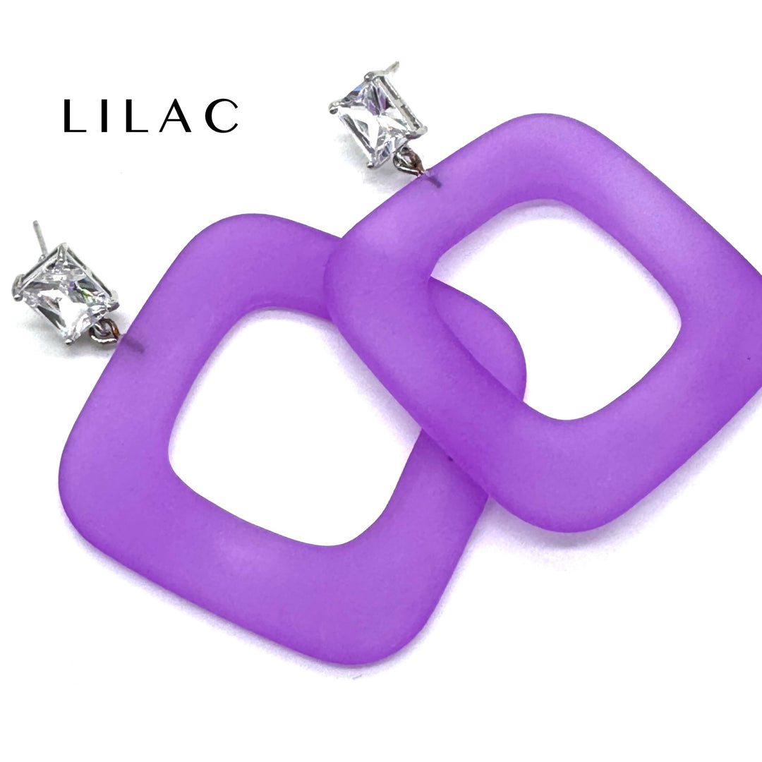 Purple square ring dangle earrings with silver post backs and clear rhinestones, shown on a white background with the brand name 'LILAC' printed in the top left.