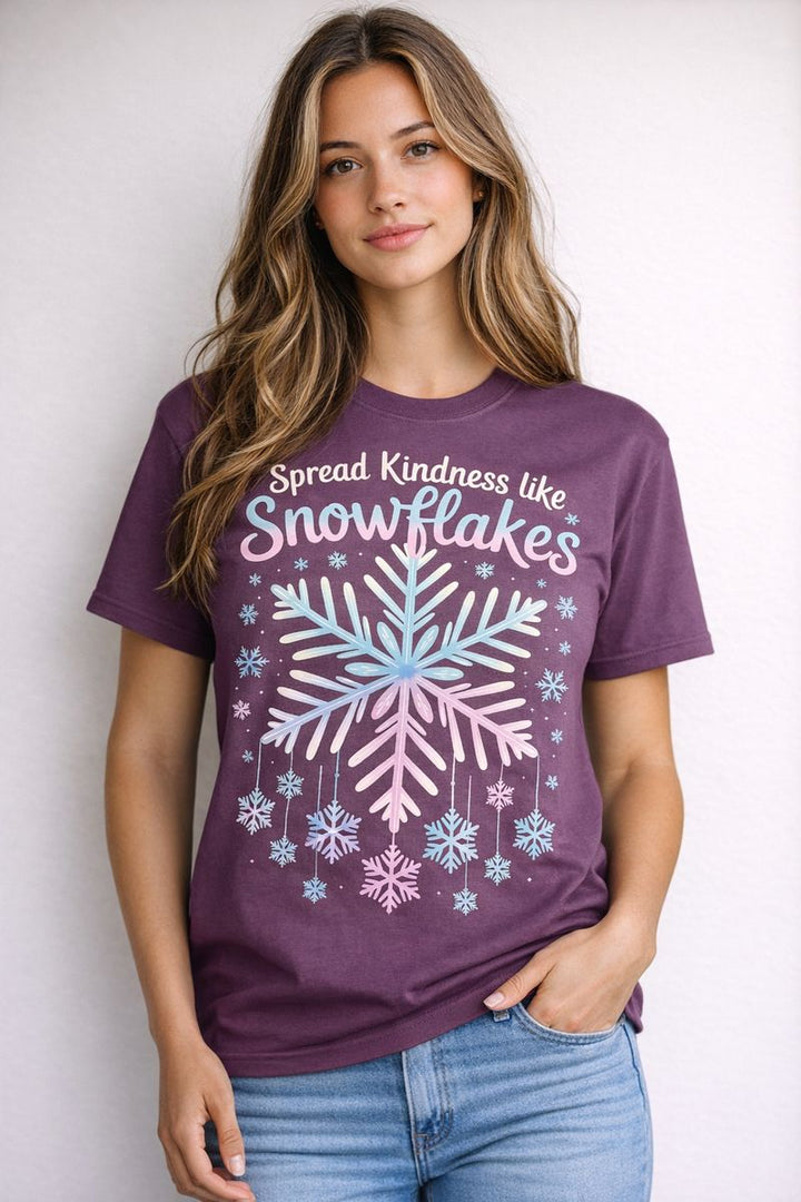 Person wearing a purple t-shirt with snowflake design and text against a plain background
