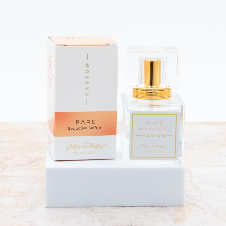 Mixologie Parfum in Bare Seductive Saffron, 1 fl oz, clear square glass spray bottle with gold cap and peach box
