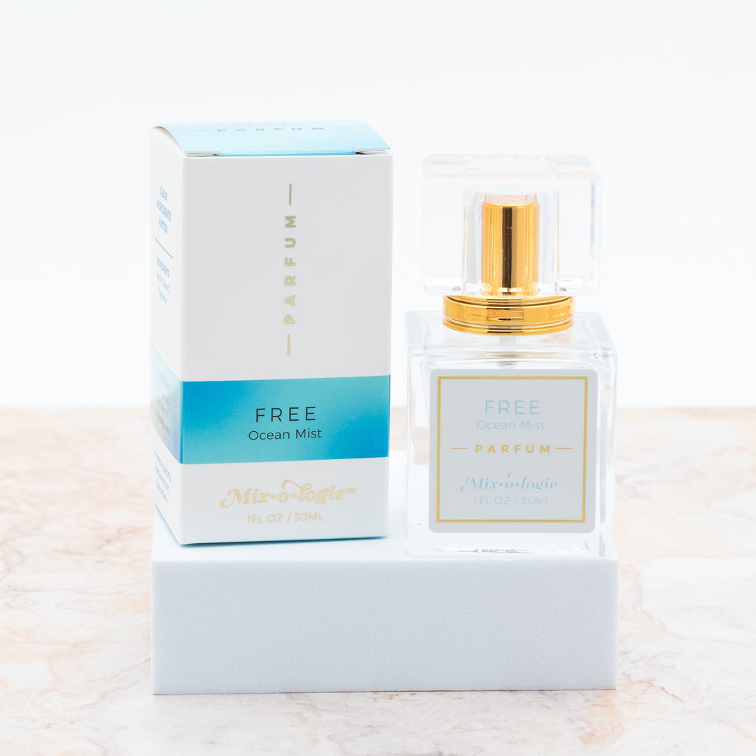 Mixologie Parfum in Free Ocean Mist, 1 fl oz, clear square glass spray bottle with gold cap and light blue box
