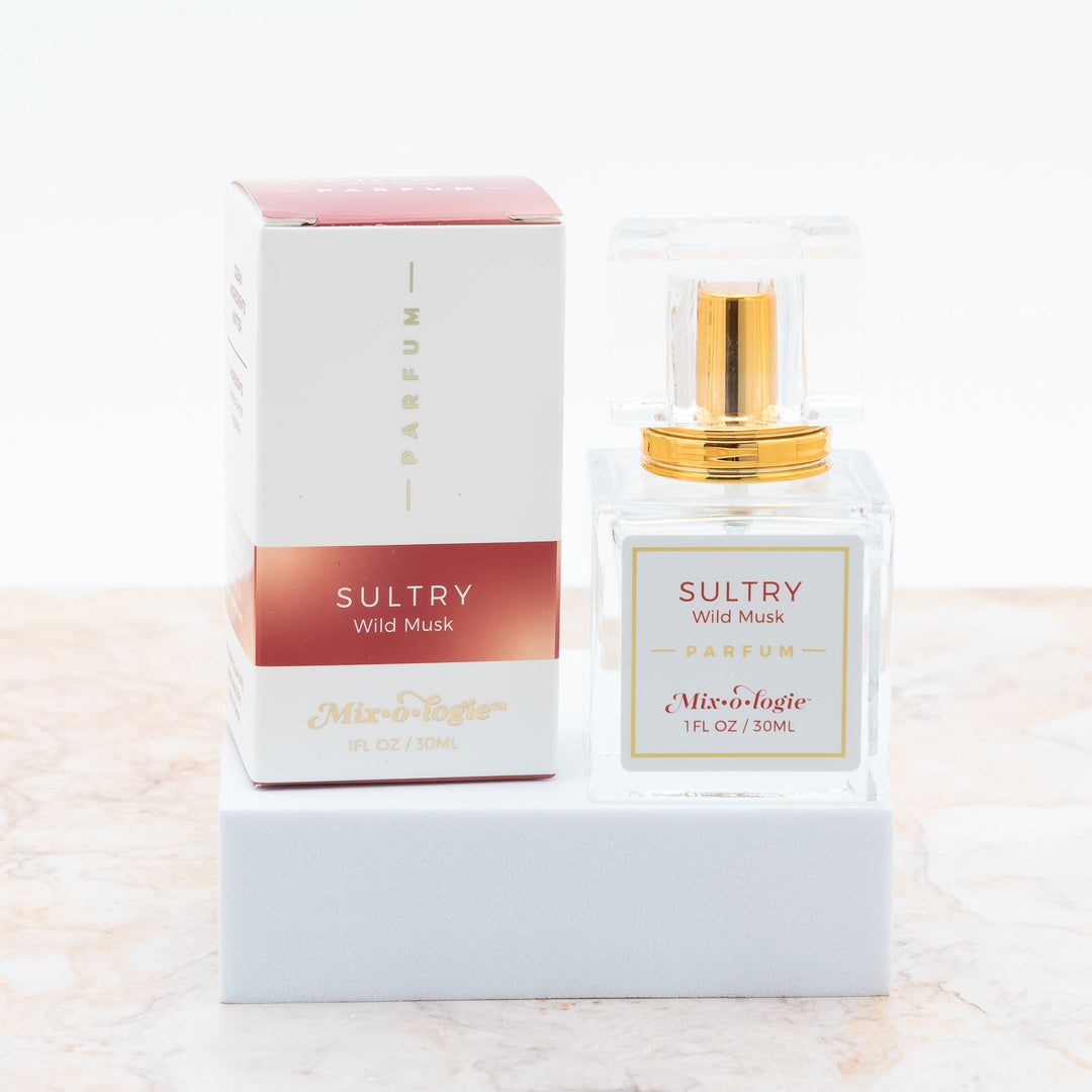 Mixologie Parfum in Sultry Wild Musk, 1 fl oz, clear square glass spray bottle with gold cap and deep red box
